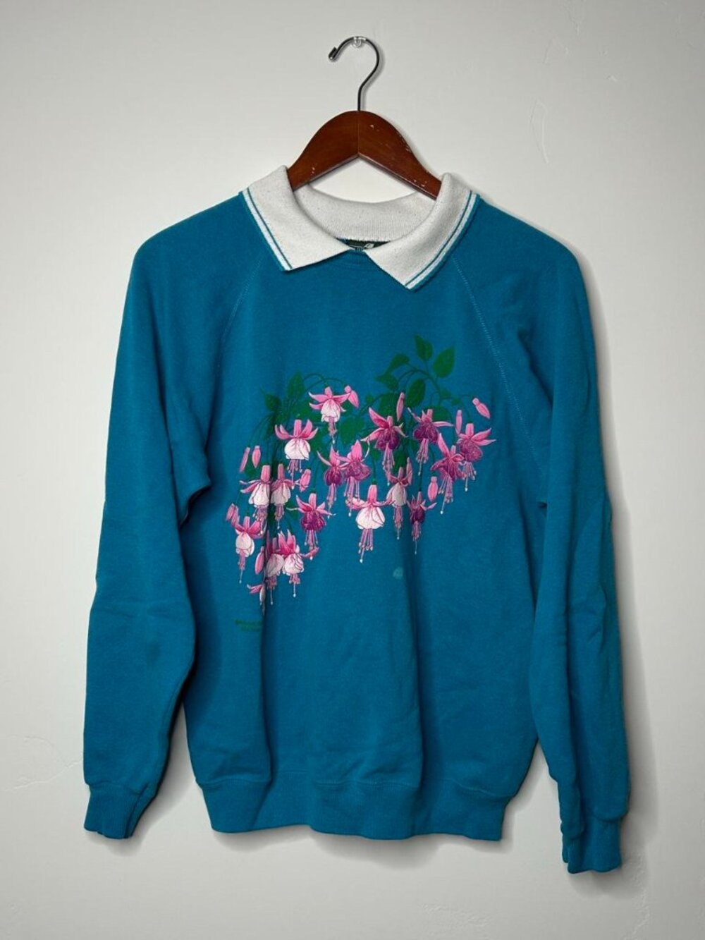 Cabin Creek blue crewneck sweatshirt with pink fuchsia flowers and green leaves
